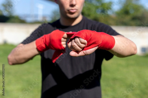 Boxer preparing for training with forearm bandage outside