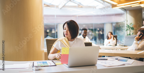 Asian businesswoman working with documents in office