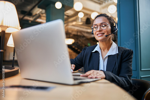 Positive delighted international female listening to interview