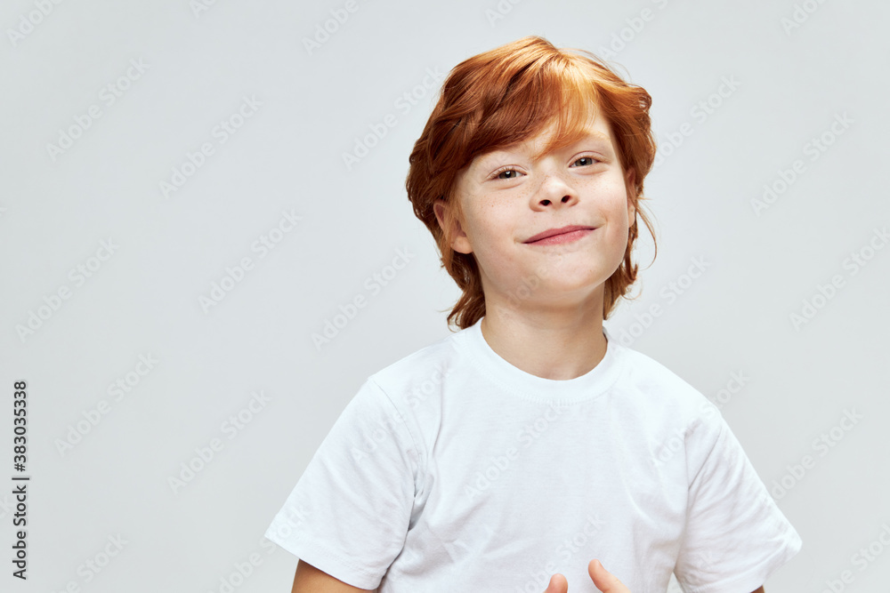 Smiling redhead child in white t-shirt cropped view Smiling redhead child in white t-shirt cropped view