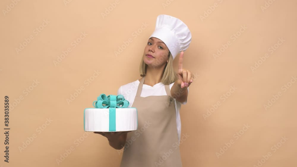 Young cook woman holding a cake having some great idea, concept of creativity Young cook woman holding a cake having some great idea, concept of creativity