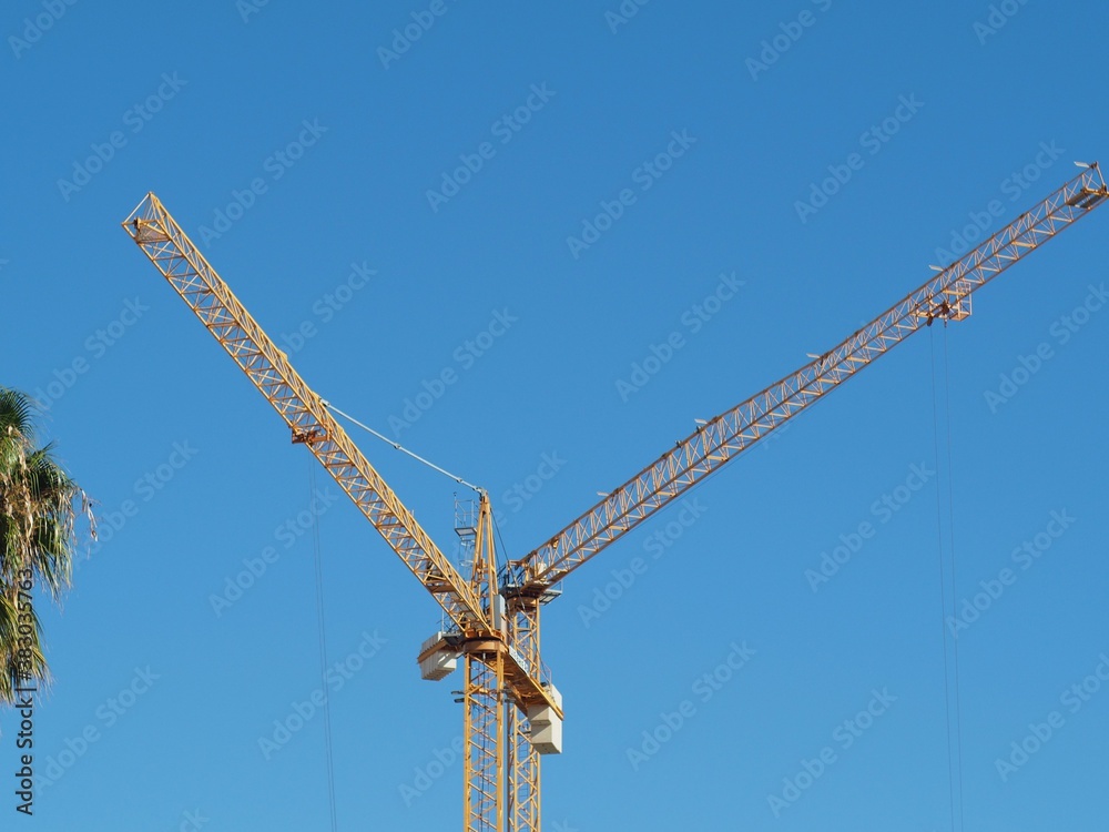 Tower cranes formed aletter V blue sky Tower cranes formed aletter V blue sky