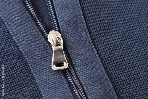 Zipper on the blue jacket. Close up. Selective focus.