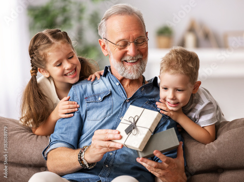 Konstfotografi Happy family aged grandfather and grandchildren girl   and boy opening gift box