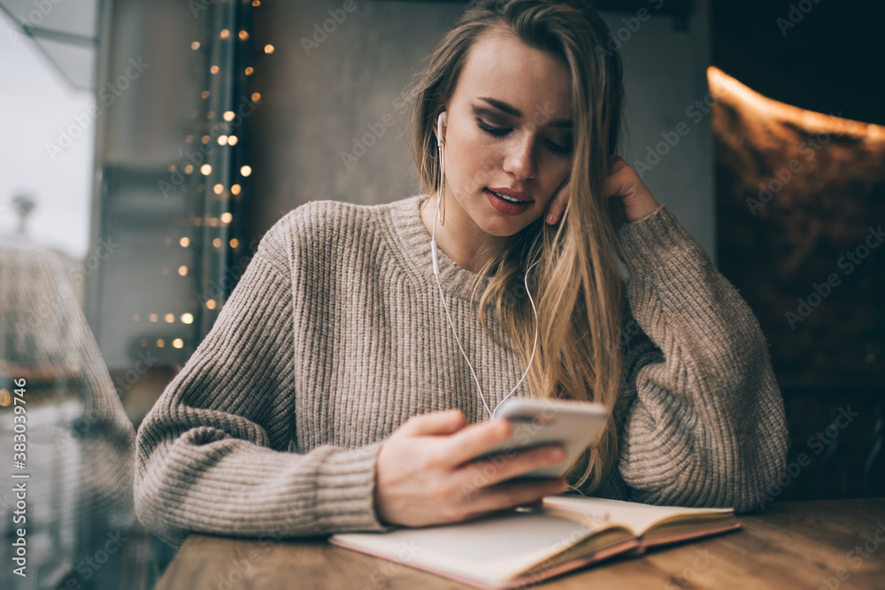 Φωτογραφία Millennial female user in modern earphones choosing music songs for listening du