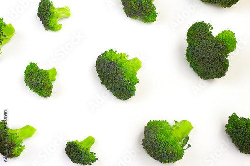 The pattern of broccoli florets. Isolate on a white background. The concept of proper nutrition, healthy vegetables, vegetarianism, dietary products. Mortgage the apartment. Top view. Copy space