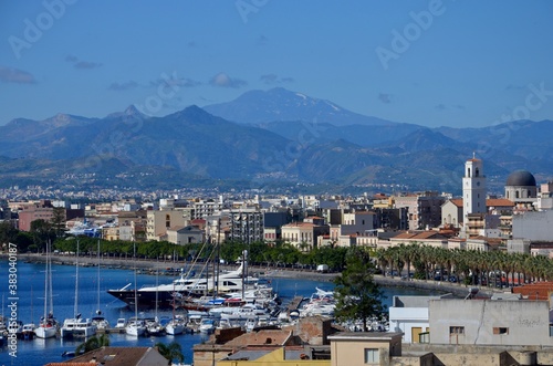 Milazzo in Sicily with view to the port, etna volcano on horizon, blue sky background © ClaudiaRMImages