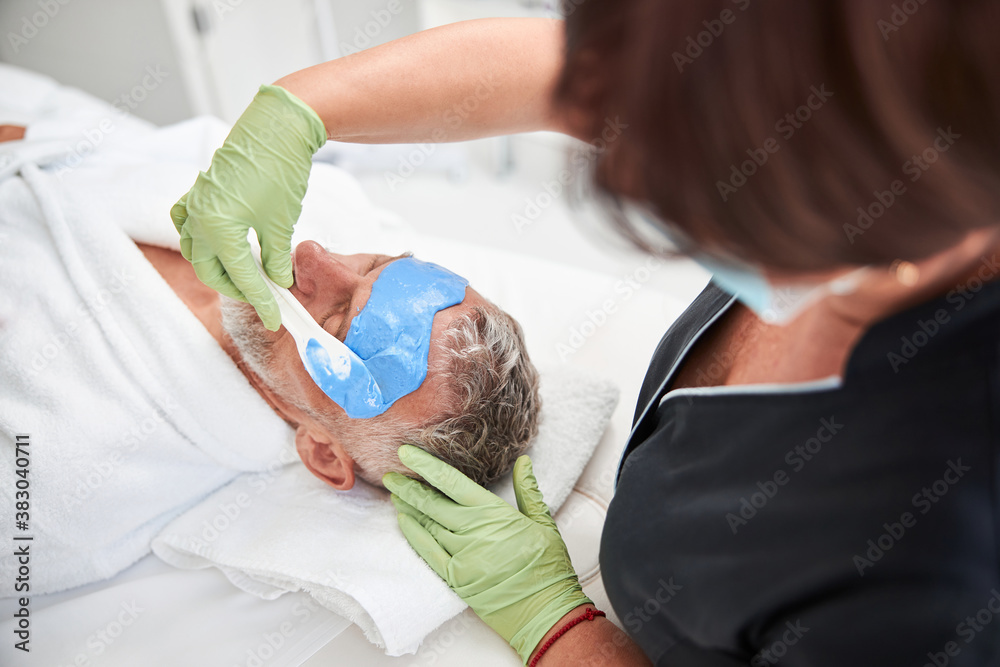 Professional spa therapist doing skincare procedures for a customer