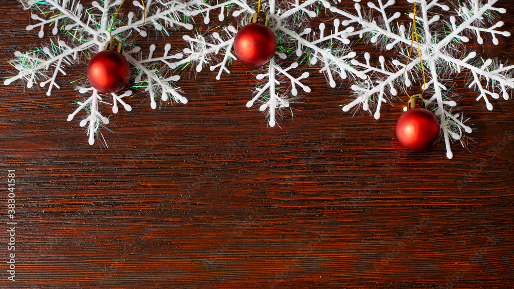 christmas brown wooden background with snowflakes, with red chrisrmas tree balls christmas brown wooden background with snowflakes, with red chrisrmas tree balls
