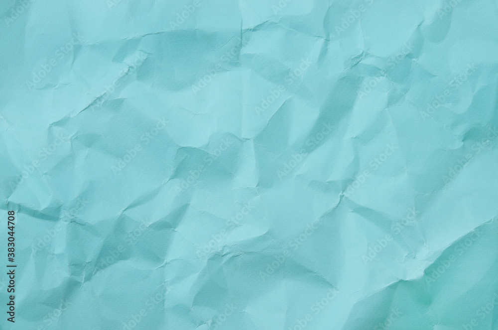 Fototapeta premium Blue background of crumpled paper.