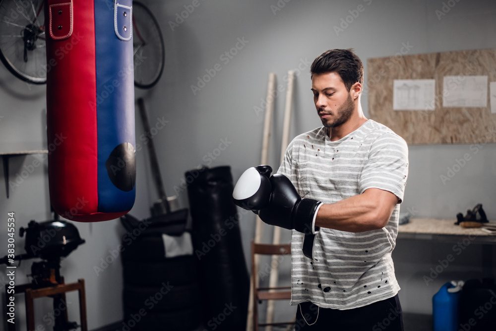 an experienced sportsman prepares for a warm up before Boxing training in his garage
