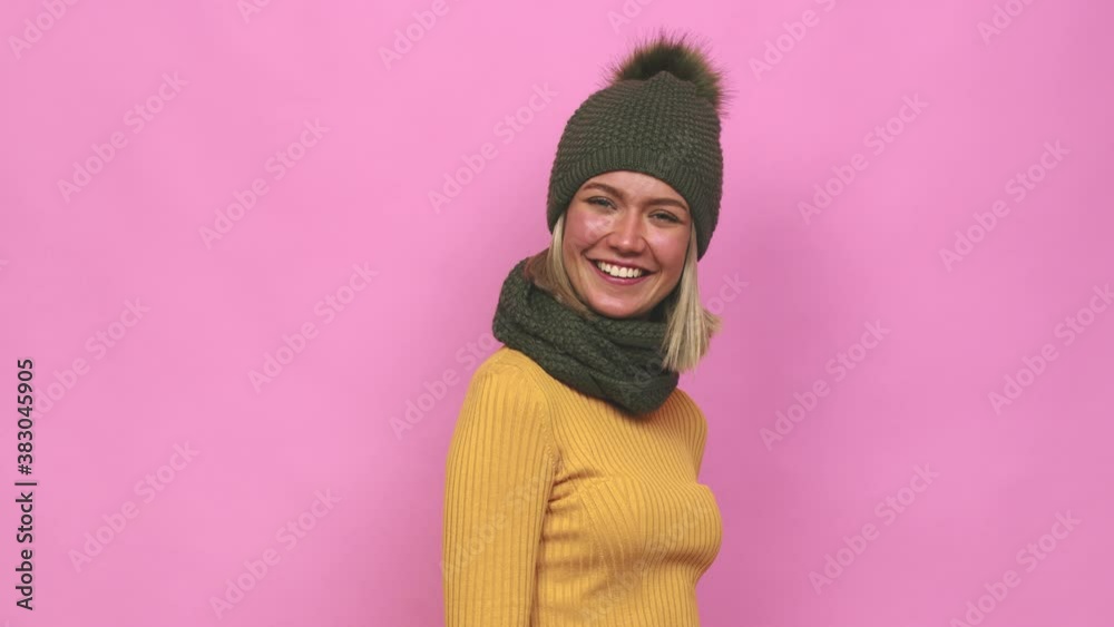 Young cute woman winter clothes looks aside smiling, cheerful and pleasant