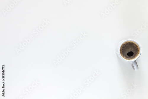 A cup of coffee on a white background. Copy space. Minimal composition. Isolated.