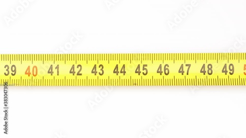 Extending measuring tape on white background photo