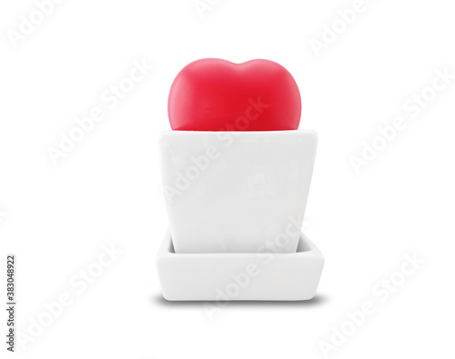 Red heart in a white square ceramic pot isolated on white background with clipping path. © Peeraya