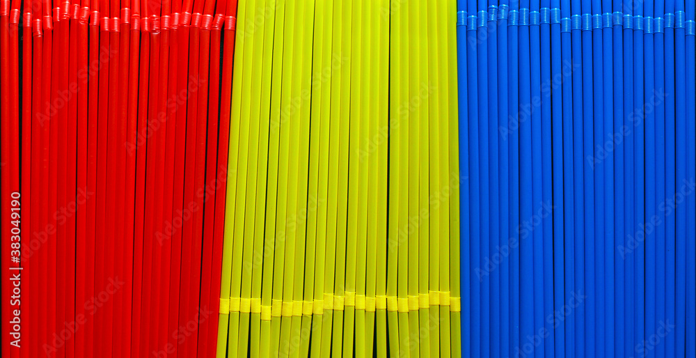 top view of red, yellow and blue straws in a row top view of red, yellow and blue straws in a row