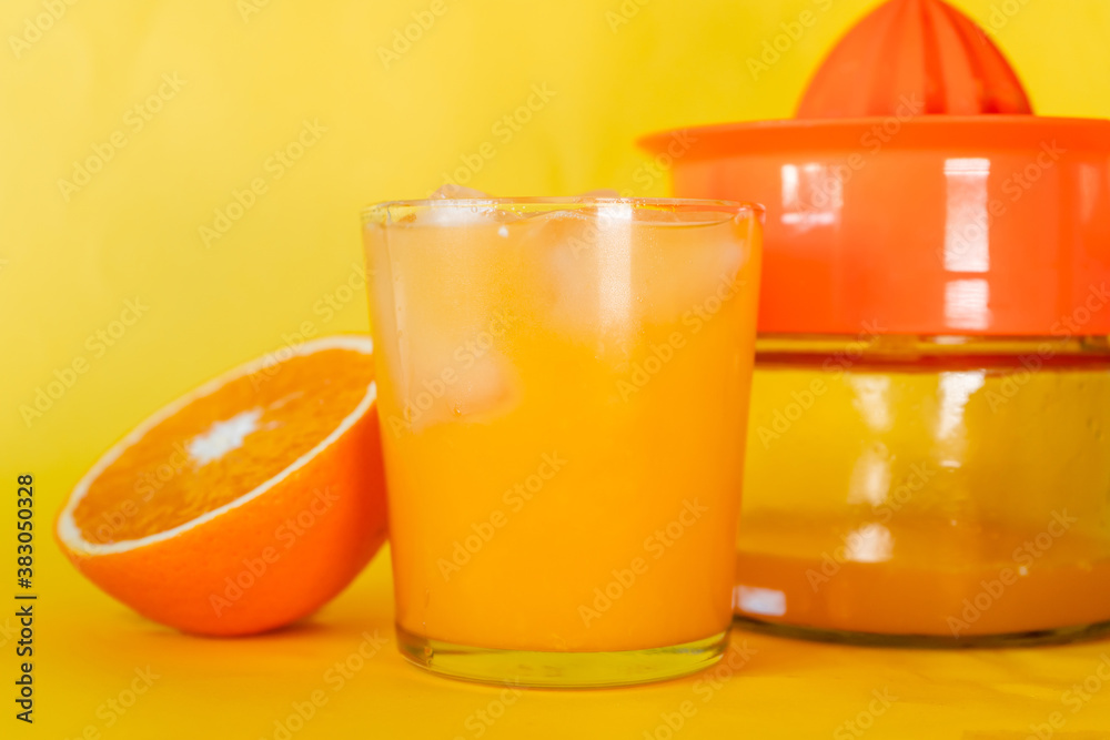 Glass of delicious organic orange juice with Half Orange and squeezer behind. Glass of delicious organic orange juice with Half Orange and squeezer behind.