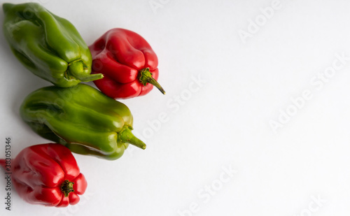 Green and red jalapeno peepers isolated on a white background.