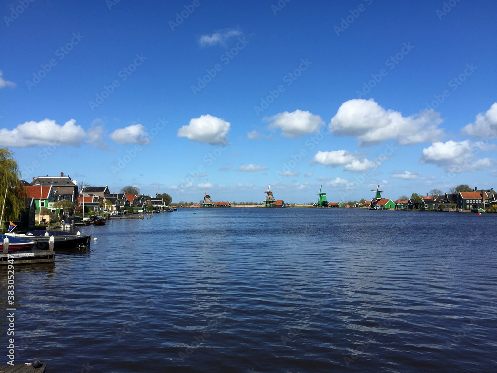 dutch historic windmills near sea coast at blue sky, in Zaanse Schans, North Holland, Netherlands