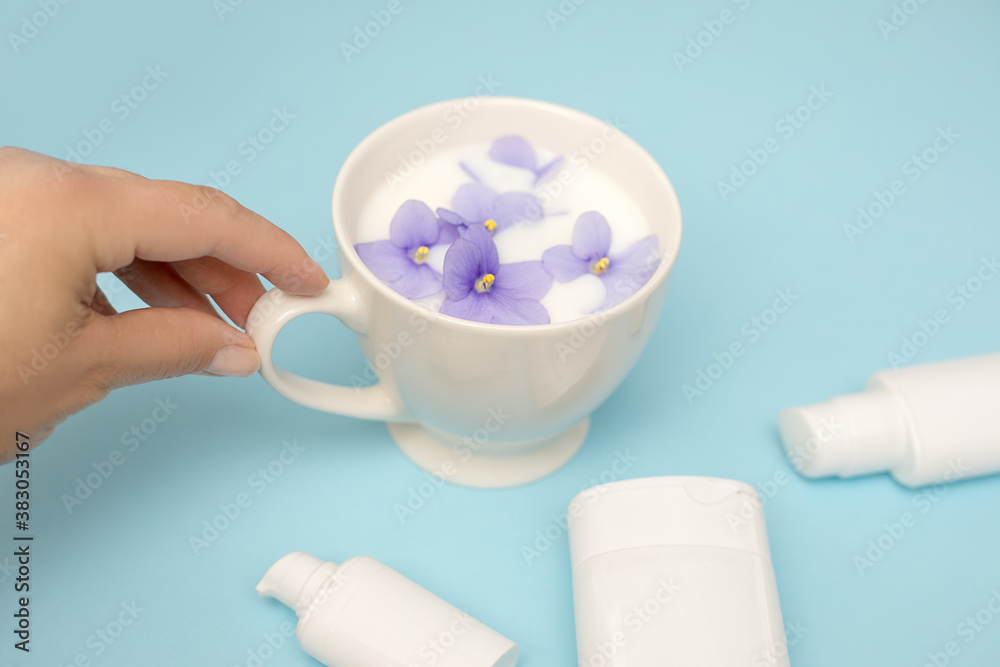Hand skin care. Closeup of beautiful woman hands . Cream for hands, spa and beauty treatment. Blue background