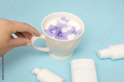 Hand skin care. Closeup of beautiful woman hands . Cream for hands, spa and beauty treatment. Blue background