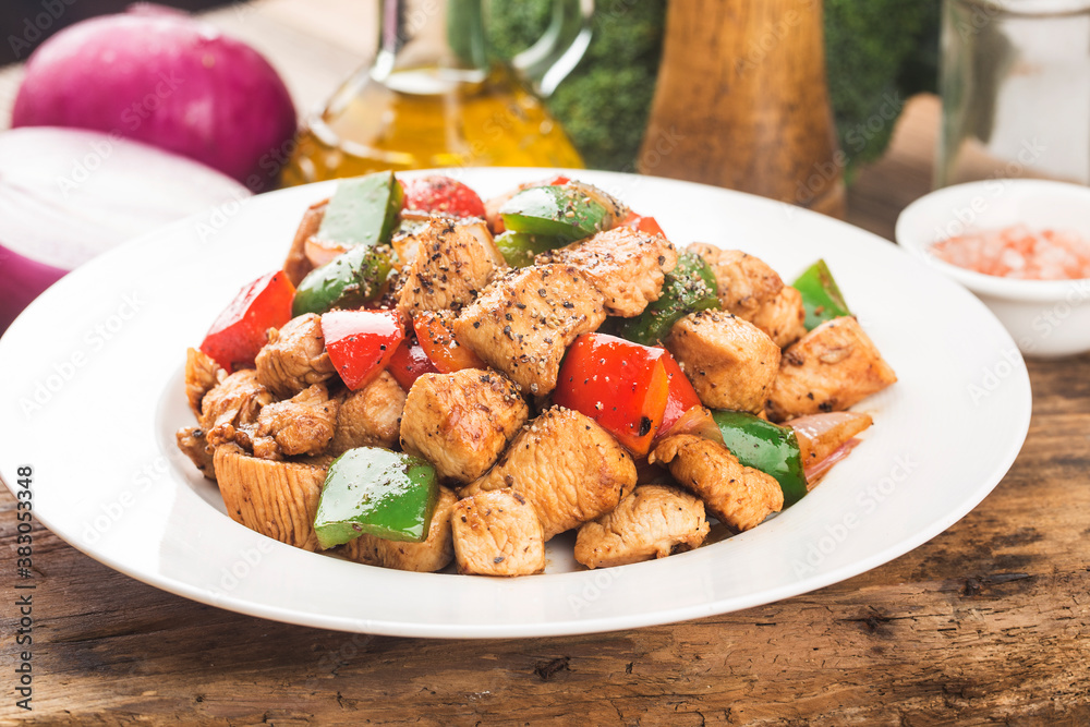A plate of fried chicken breast with colored pepper A plate of fried chicken breast with colored pepper