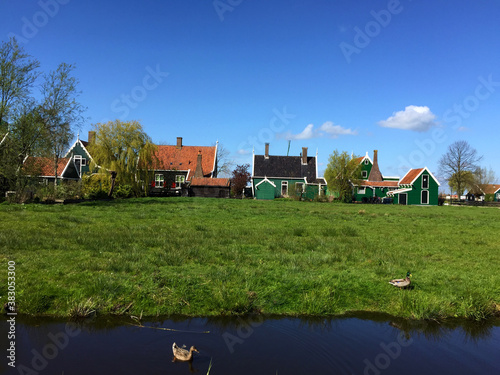 landscape with village and river against blue sky in Zaanse Schans, North Holland, Netherlands