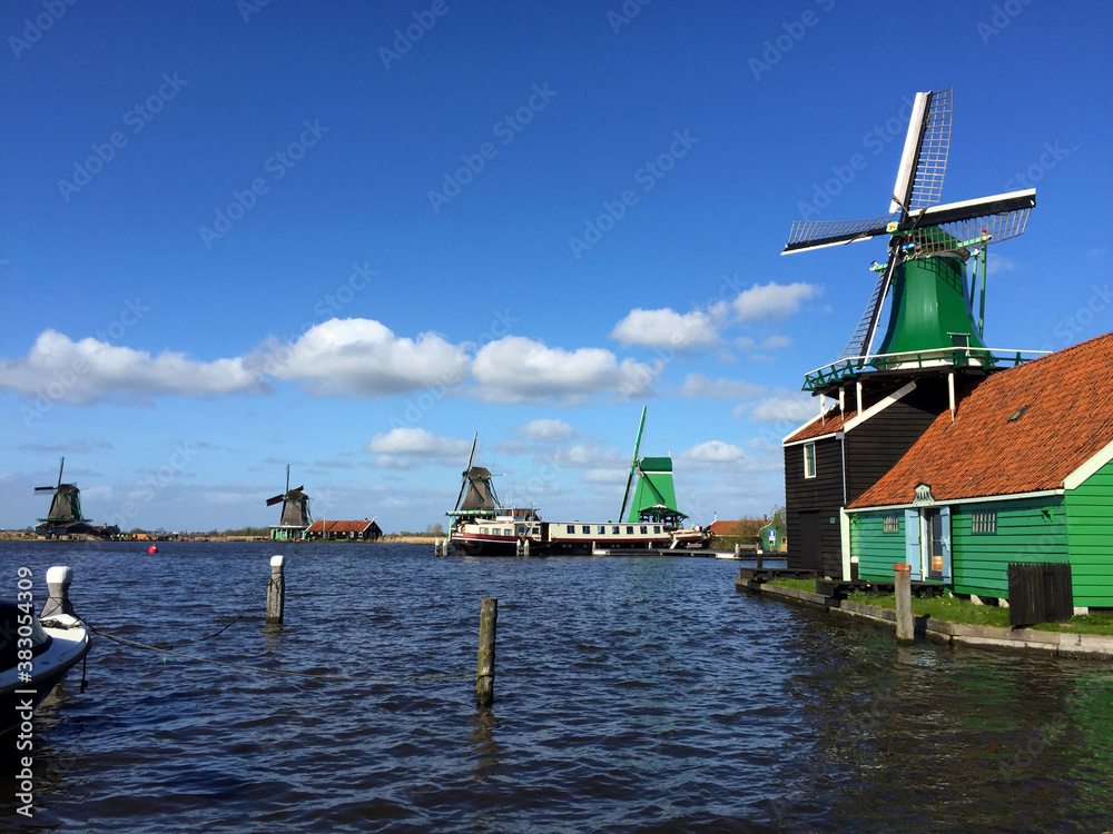 dutch historic windmills near sea coast at blue sky, in Zaanse Schans, North Holland, Netherlands