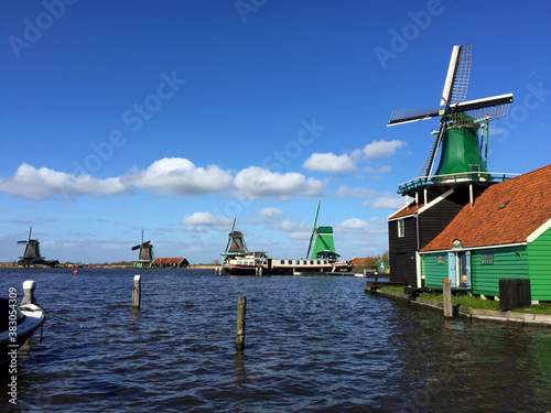 dutch historic windmills near sea coast at blue sky, in Zaanse Schans, North Holland, Netherlands