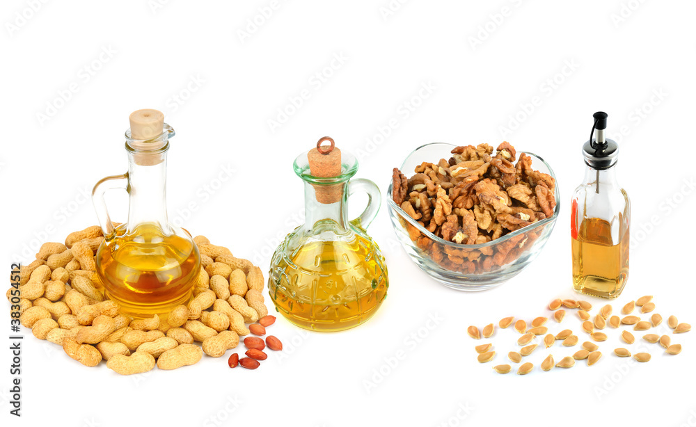 Set of vegetable oils, nuts and seeds isolated on white background