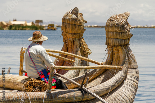 Uro men sailing on a totora boat at titikaka lake photo