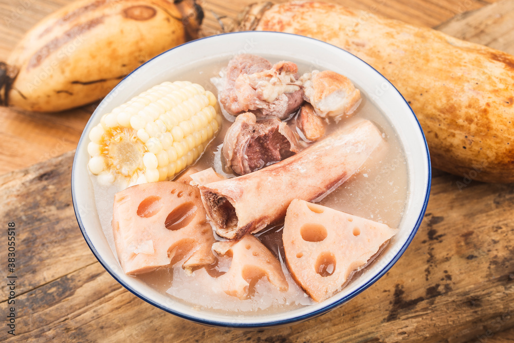 A bowl of pork bone lotus root soup on a wooden table