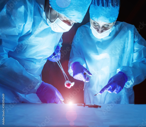Two doctors perform laser surgery to treat varicose veins and hemorrhoids. Concept laser surgery photo