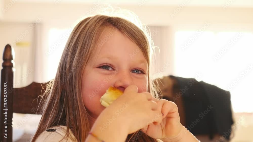close up caucasian happy girl eating a sandwich bread at home table close up caucasian happy girl eating a sandwich bread at home table