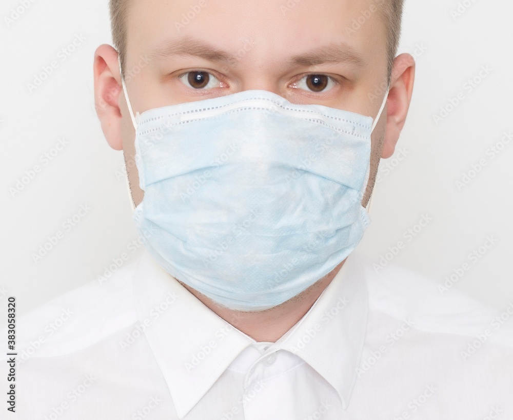 Young caucasian man in protective medical mask on white background, second wave of coronavirus and pandemic concept, portrait Young caucasian man in protective medical mask on white background, second wave of coronavirus and pandemic concept, portrait