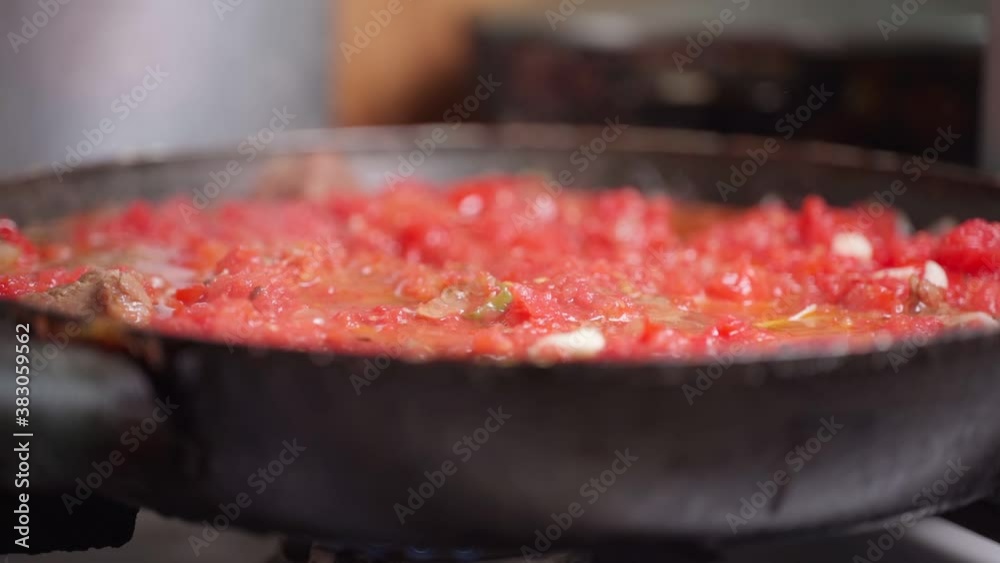 Tomato and meat are cooked in a skillet Tomato and meat are cooked in a skillet