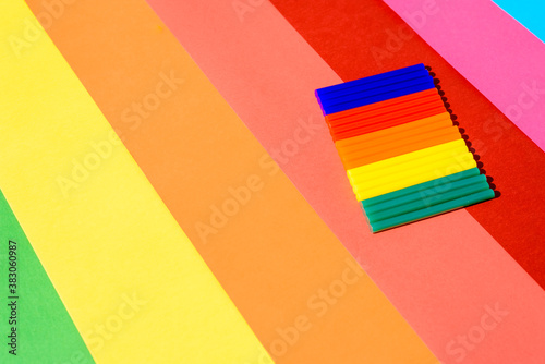 Colorful silicone glue sticks on a background of vibrant lines.