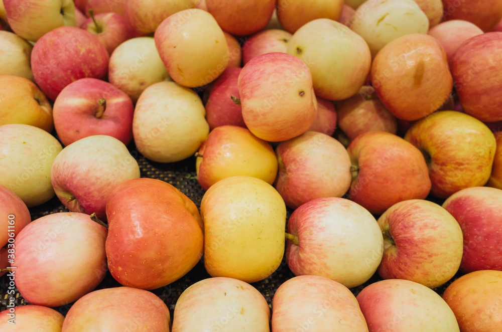 Closeup of many pink raw vibrant colorful red green color apples in market Closeup of many pink raw vibrant colorful red green color apples in market