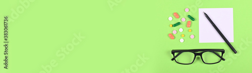 Wallpaper Mural Medical pills on green background, flat lay, overhead view image, copy space template, banner. Torontodigital.ca