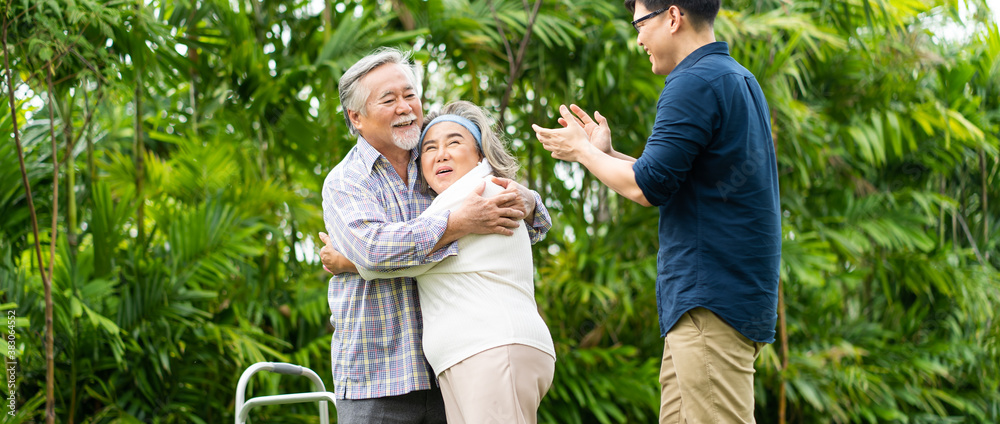 Asian family with love. 4 People. happy family shows love by hugging each other on the lawn at home. Asian family with love. 4 People. happy family shows love by hugging each other on the lawn at home.