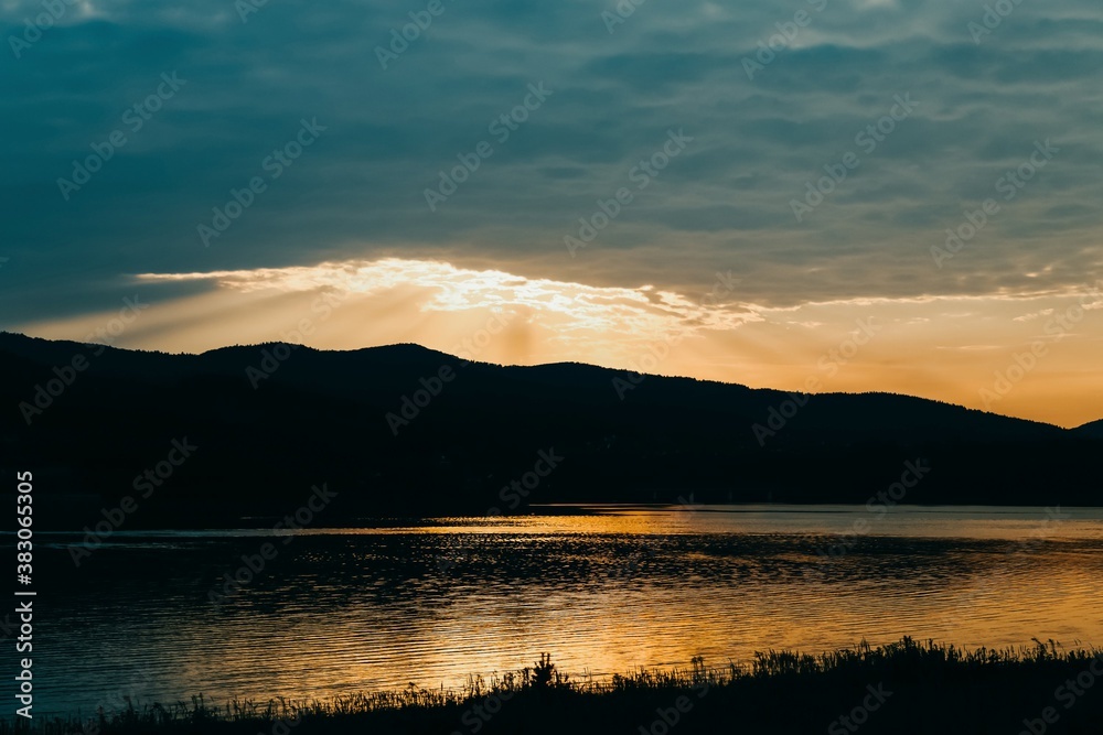 Sunset reflected in lake water. Lake Mucharz. Jezioro Mucharskie, Poland