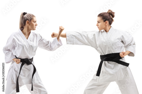 Young females in kimono practicing karate