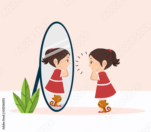 little girl with cat standing in front of the mirror