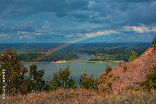 Rainbow with clouds over a ...