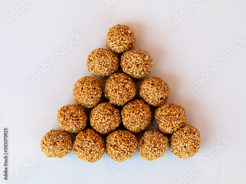 White sesame seed balls made with heated  jiggery against white background