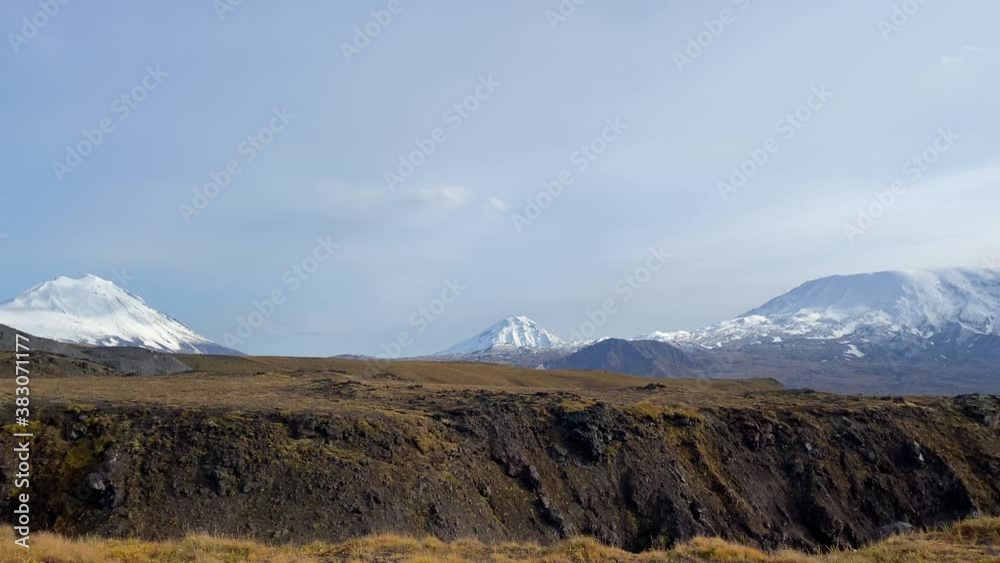 Amazing view of the volcanoes of central Kamchatka. Klyuchevskoy Volcano Park. Aerial view of the tundra and lava plains. A beautiful volcanic site. Amazing view of the volcanoes of central Kamchatka. Klyuchevskoy Volcano Park. Aerial view of the tundra and lava plains. A beautiful volcanic site.