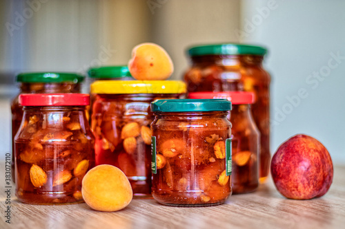 Jam from apricots in a glass jar on the table