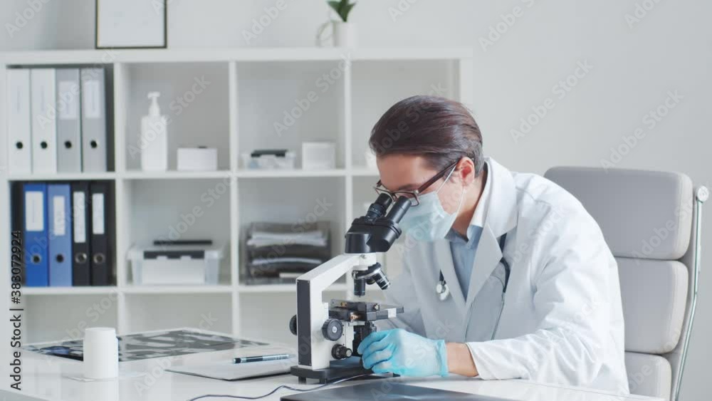 Professional medical doctor working in laboratory using microscope. Professional medical doctor working in laboratory using microscope.