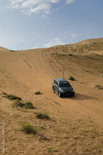 Green off-road car in the sand. Badain Jaran Desert-Inner Mongolia-China-1080