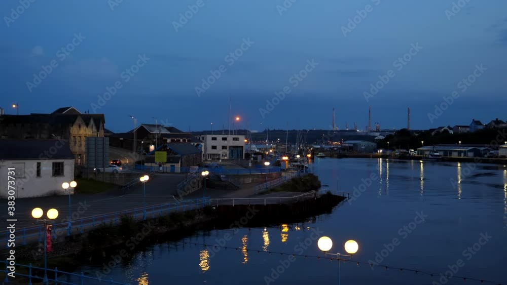 Welsh town Milford Haven at night. Power station chimneys seen in the background. Welsh town Milford Haven at night. Power station chimneys seen in the background.